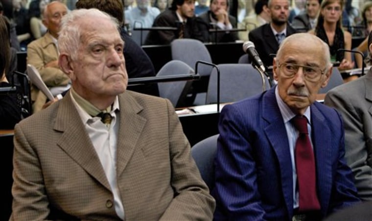 Former dictators Jorge Rafael Videla, right, and Reynaldo Bignone attend their trial in Buenos Aires, Argentina, on Monday. Videla and Bignone face life sentences if convicted on charges of implementing a systematic plan to steal the babies of political prisoners during the 1976-1983 dictatorships. Also charged are six other former military and police officials. 